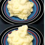 A bowl of creamy mashed potatoes, perfectly whipped to a smooth texture, topped with a pat of butter and garnished with freshly chopped parsley.