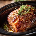 Freshly baked Sweet Holiday Magic dessert dusted with powdered sugar, served on a cozy Christmas table with festive lights in the background.