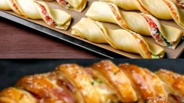 Golden, flaky puff pastry appetizers filled with creamy cheese and herbs, served on a festive wooden board.