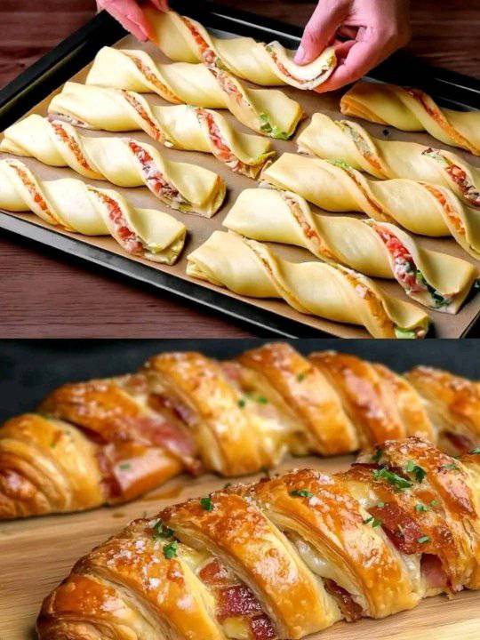 Golden, flaky puff pastry appetizers filled with creamy cheese and herbs, served on a festive wooden board.